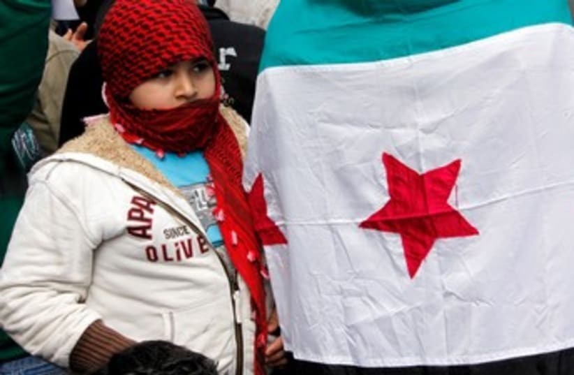 Child near Syria opposition flag 370 (photo credit: MOHAMED AZAKIR)