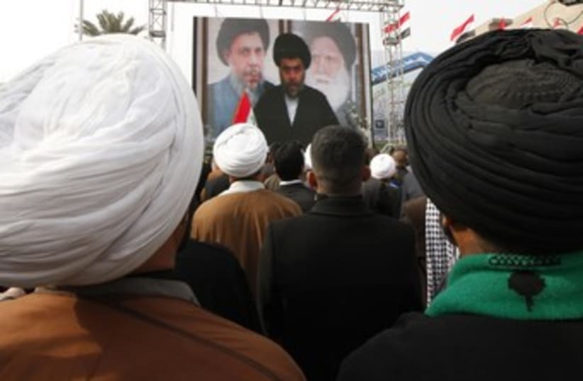 Supporters watch a Moqtada al-Sadr speech 370 (R) (photo credit: Mohammed Ameen / Reuters)