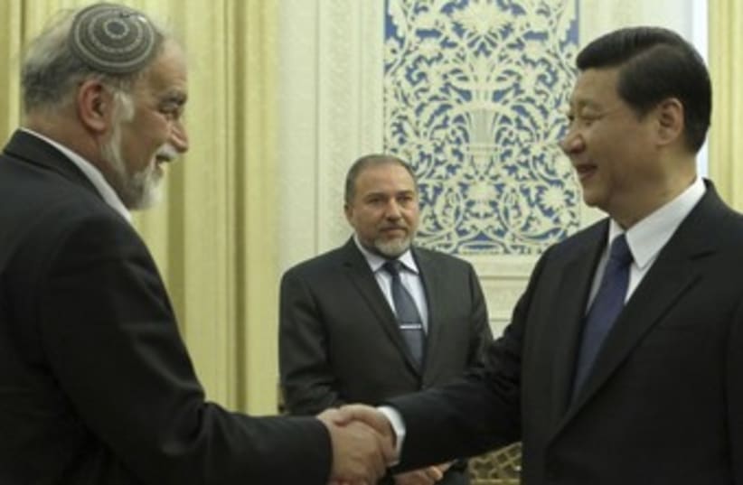 Liberman looks on as Chinese VP Xi Jinping meets Rotem_370 (photo credit: Reuters/China Daily)