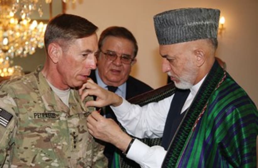 Afghan President Karzai with then Gen. Petraeus 370 (R) (photo credit: Reuters)