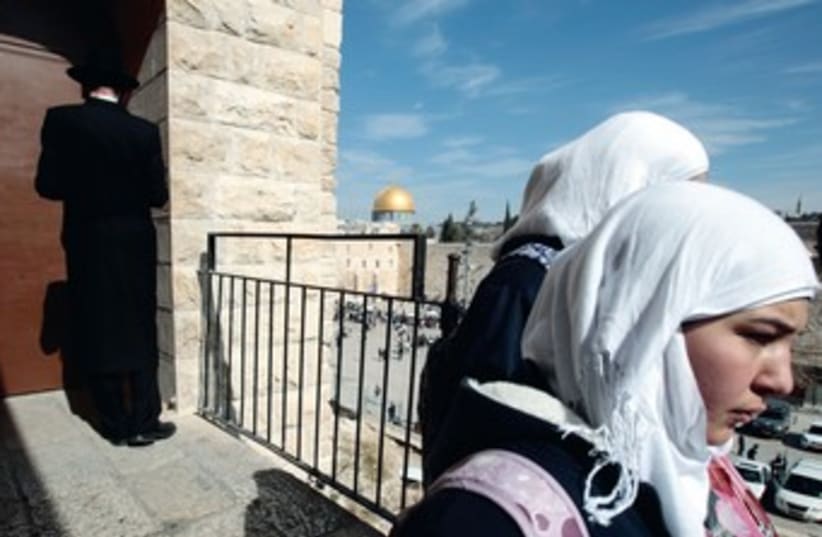 Arab women an haredi man in Jerusalem 370 (photo credit: REUTERS)