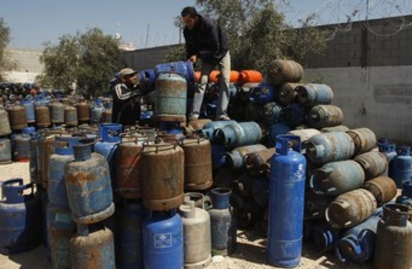 Gazans arrange gas cylinders at gas filling station  R (photo credit: REUTERS)
