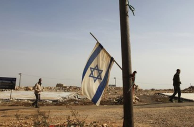 Israeli flag hangs off pole in Migron 370 R (photo credit: REUTERS)
