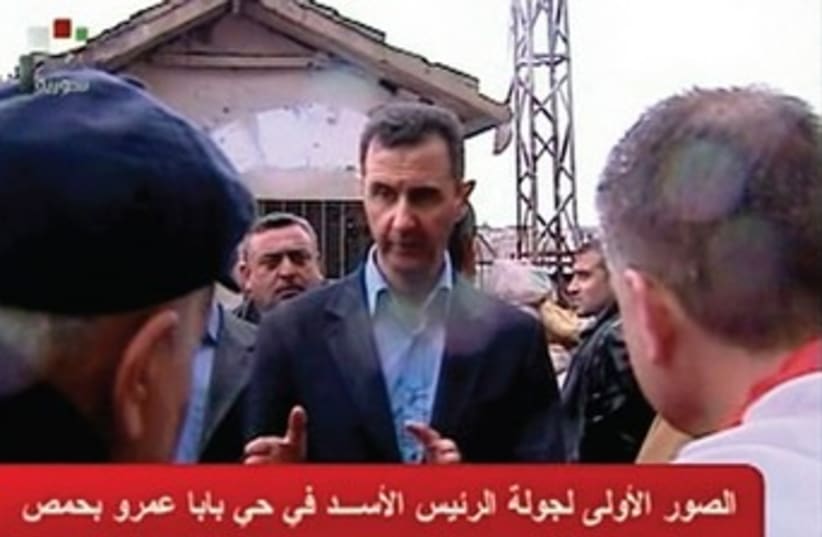 Assad visits Homs 370 (photo credit: Syrian TV/Reuters)