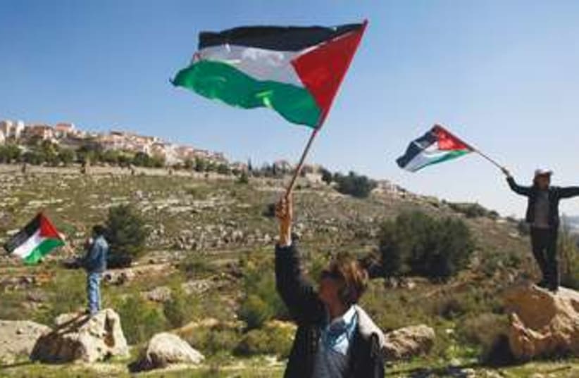 Palestinian flags waving in West Bank 370 (photo credit: Reuters)