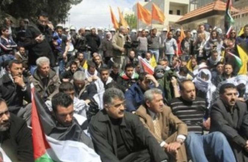 Palestinian protesters sittingnear Bethlehem on Land Day 370 (photo credit: TOVAH LAZAROFF)