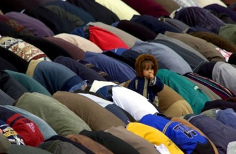 Child amongst crowd of praying Muslims 370 (photo credit: REUTERS/Radu Sigheti)