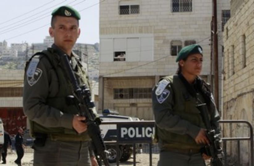 Israel border police stand guard in Hebron_370 (photo credit: Ammar Awad/Reuters)