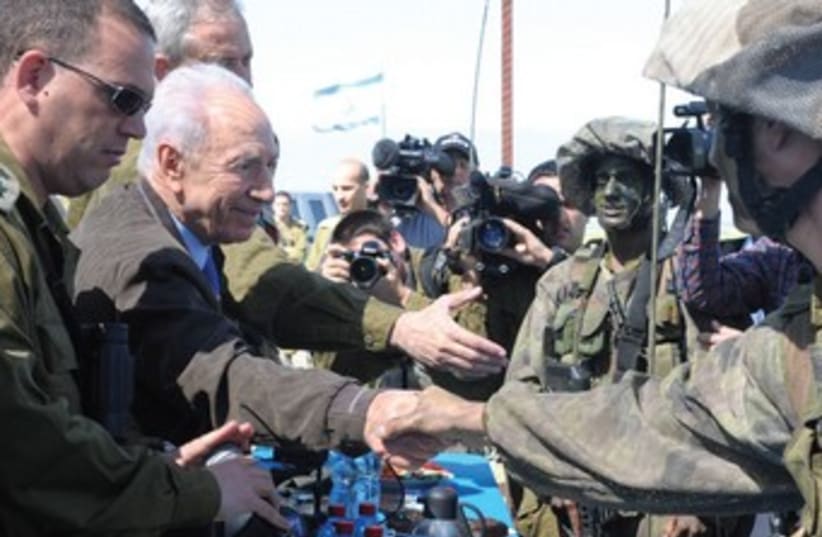 President Peres shakes hands with  7th Brigade soldiers 370 (photo credit: Mark Neiman/GPO)