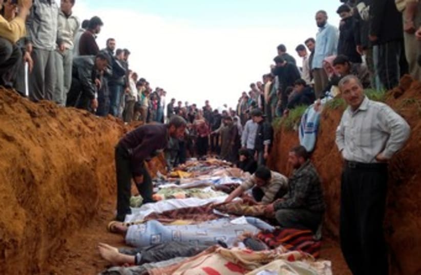 Anti-Assad Syrians bury dead 370 (photo credit: HANDOUT)