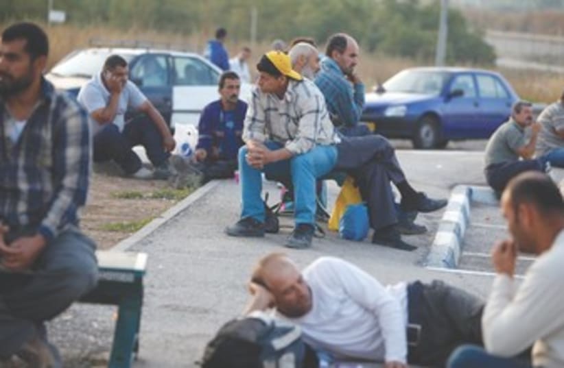 Working class Palestinians sitting around 370 (photo credit: REUTERS)