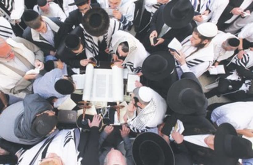 JEWISH WORSHIPERS cover themselves with prayer shawls  370 (photo credit: Marc Israel Sellem/The Jerusalem Post)