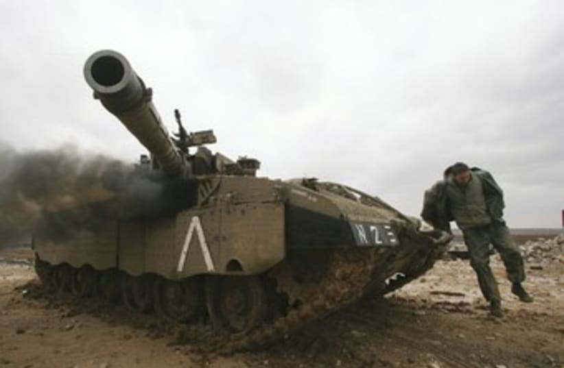 IDF soldier, tank outside northern Gaza 370 (photo credit: Reuters)