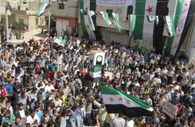 Syrians demonstrate near Homs 370 (R) (photo credit: REUTERS/Shaam News Network)