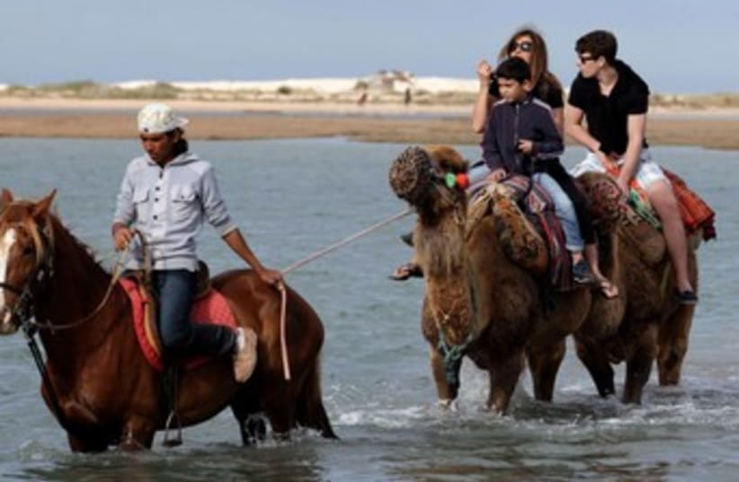 Tourists ride animals in Djerba, Tunisia 370 (photo credit: REUTERS)