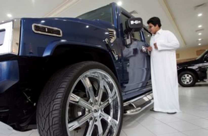 Saudi man in a car showroom 370 (R) (photo credit: Zainal Abd Halim / Reuters)