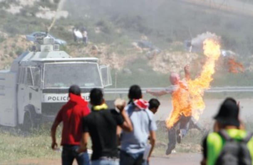 Stone-throwing Palestinian 370 (photo credit: Reuters)