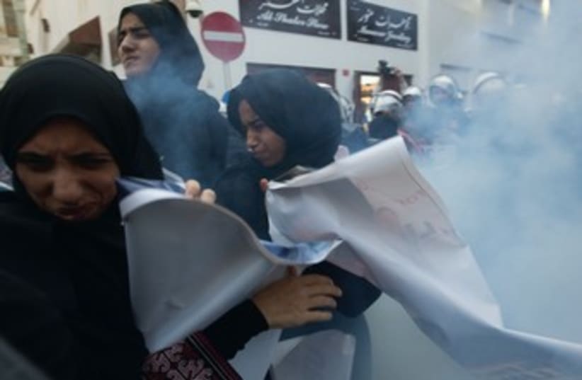 Protesters in Manama react to sound grenade 370 (photo credit: reuters)