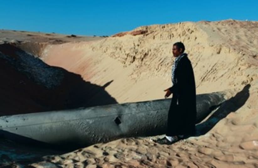 BEDUIN man looks at a gas pipeline in Sinai 370 (photo credit: REUTERS)