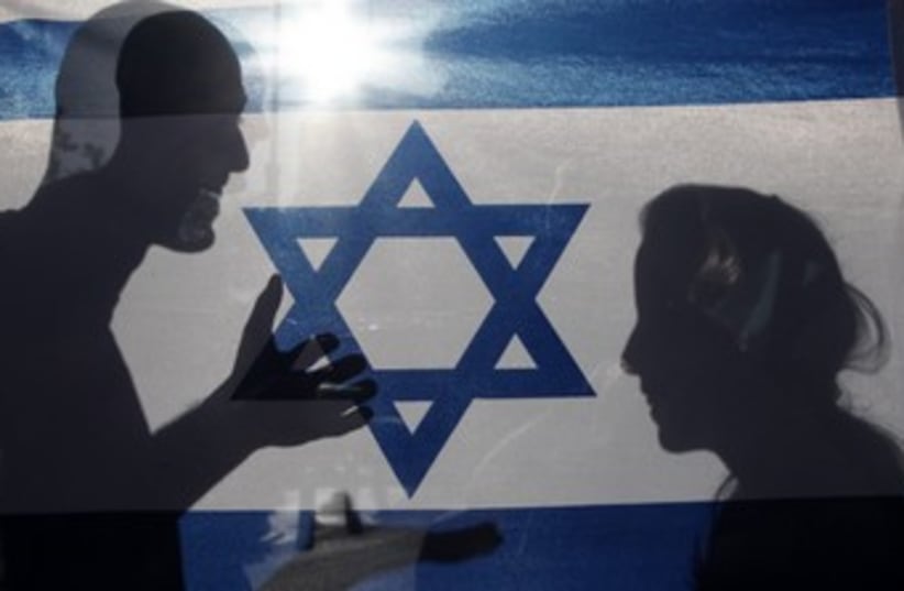 Shadow of couple on Israeli flag 370 (photo credit: Marc Israel Sellem)