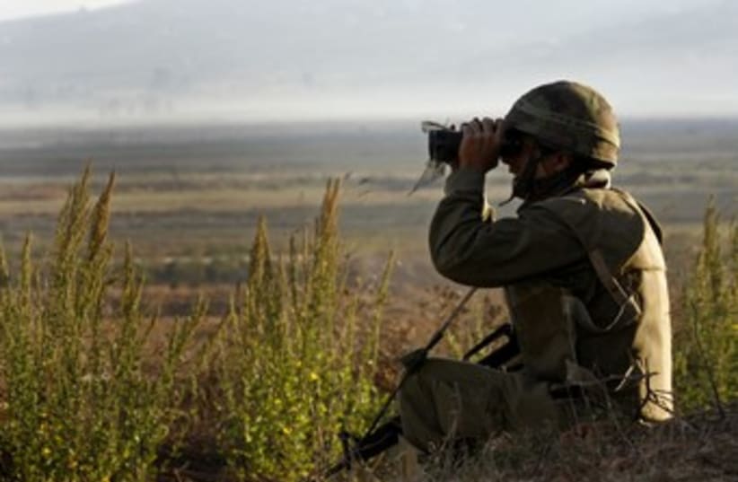 IDF soldier with binoculars 370  (photo credit: REUTERS/Finbarr O'Reilly)