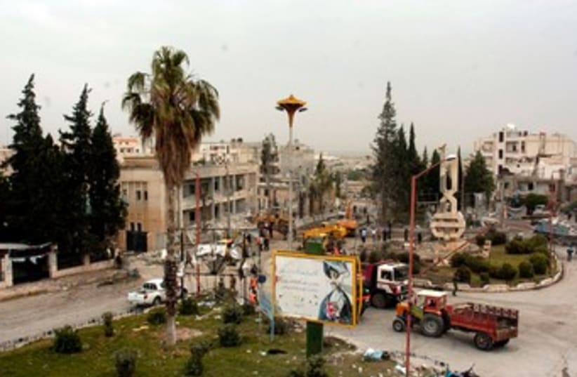 Site of bomb blast in Syria's Idlib 370 (photo credit: REUTERS/SANA/Handout )