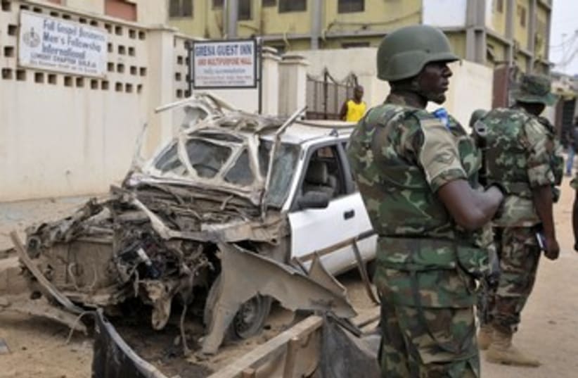 Nigerian soldiers at bomb site near Abuja 370 (photo credit: REUTERS/Afolabi Sotunde)