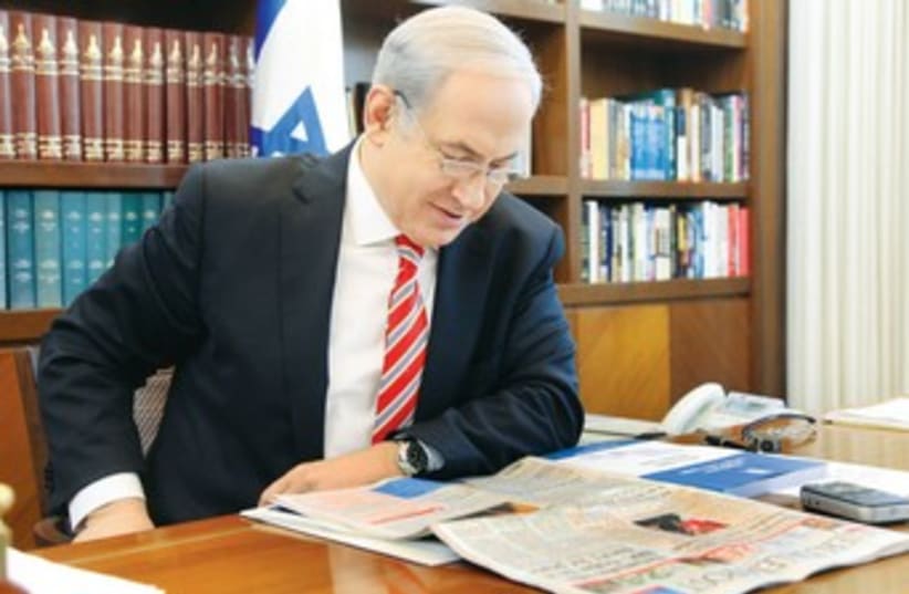 PM Netanyahu reading 'The Jerusalem Post' 370 (photo credit: Marc Israel Sellem)