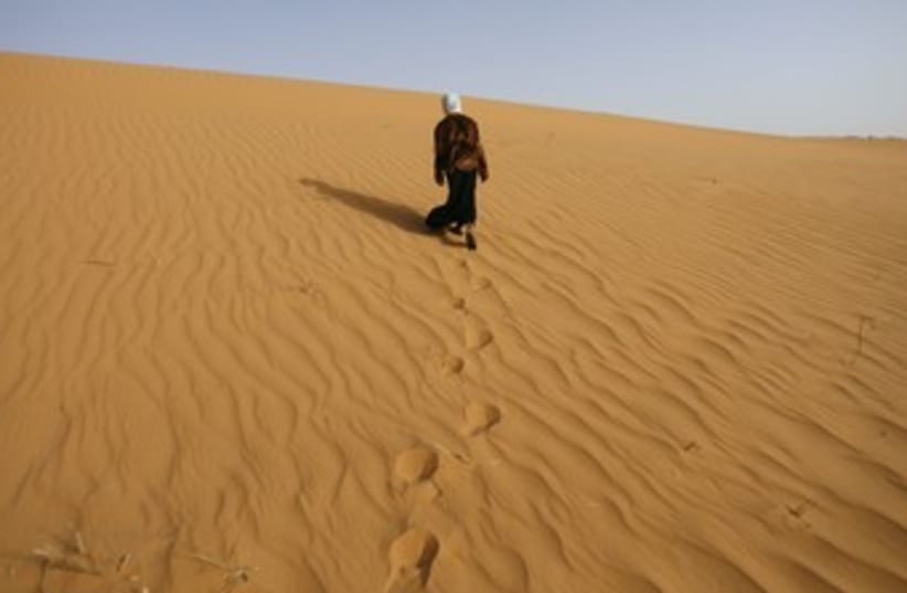 A girl walks near Ouled Said ksar, Sahel_370 (photo credit: Zohra Bensemra/Reuters)