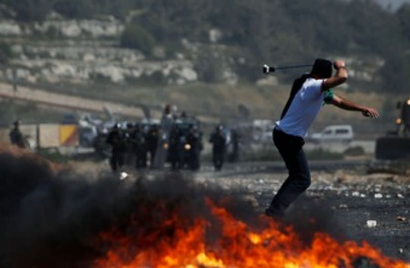 Palestinian throws stone at Beitunia Nakba Day protest 370 R (photo credit: REUTERS/Darren Whiteside)