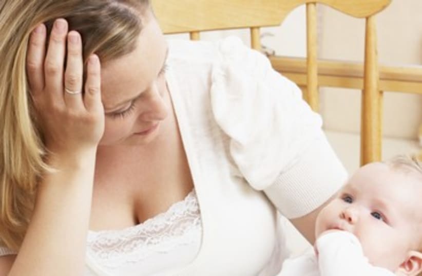 A worried mother holding her baby 370 (photo credit: Thinkstock/Imagebank)