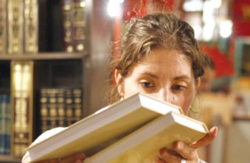 A woman searches through books 370 (photo credit: Ariel Jerozolimski)