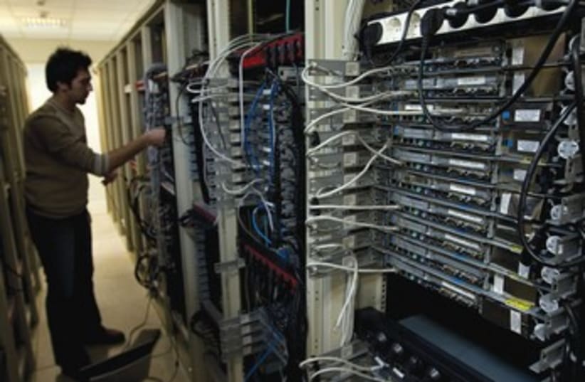 Engineer checks equipment at Tehran internet service 370 (photo credit: REUTERS)