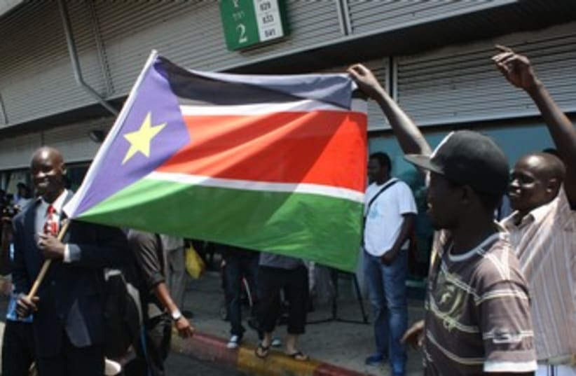 Migrants dance with South Sudanese flag 370 (photo credit: Ben Hartman)