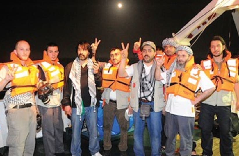 Activists pose on Mavi Marmara 370 (photo credit: Reuters)