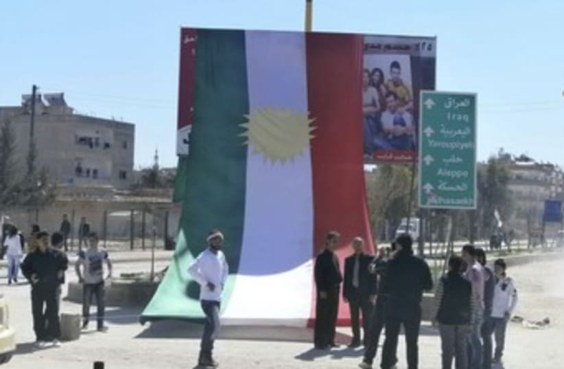 Kurds erect large Kurdistan flag in Syria protest 370 (photo credit: REUTERS/Handout .)