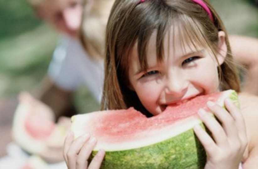 Girl eating watermelon (photo credit: Thinkstock)