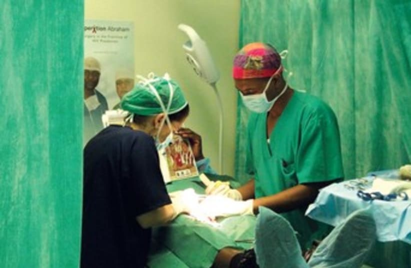 Doctors perform circumcision 370 (photo credit: Courtesy Operation Abraham)