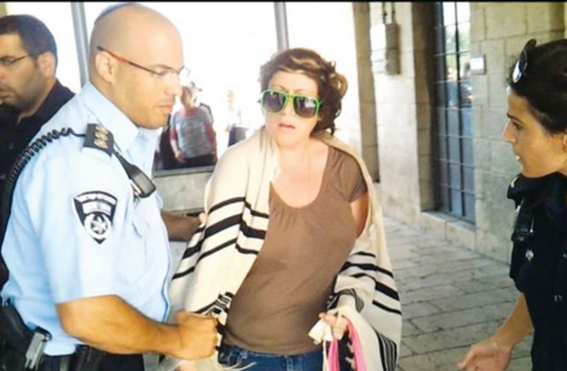 Police officer detains Deborah Houben at Western Wall Plaza  (photo credit: Women of the Wall)