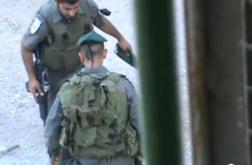 Border Police officers seen kicking Hebron child 370 (photo credit: YoutTube / B'Tselem)