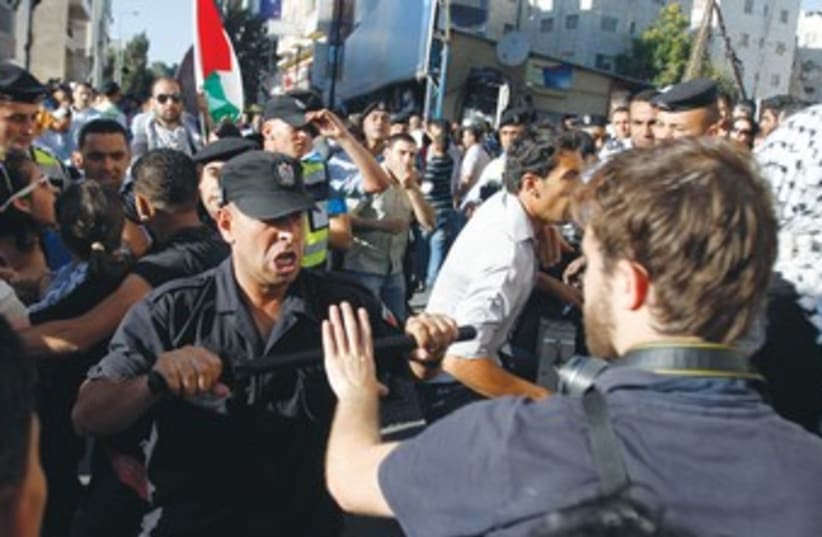 Palestinian security confronts journalist in Ramallah 370 (photo credit: REUTERS)
