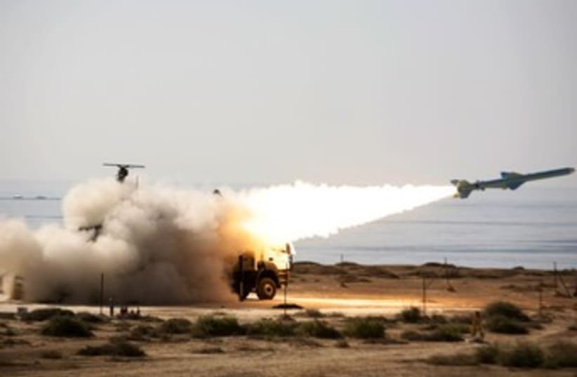 An Iranian Qader long-range missile is fired 370 (R) (photo credit: Reuters/Handout)