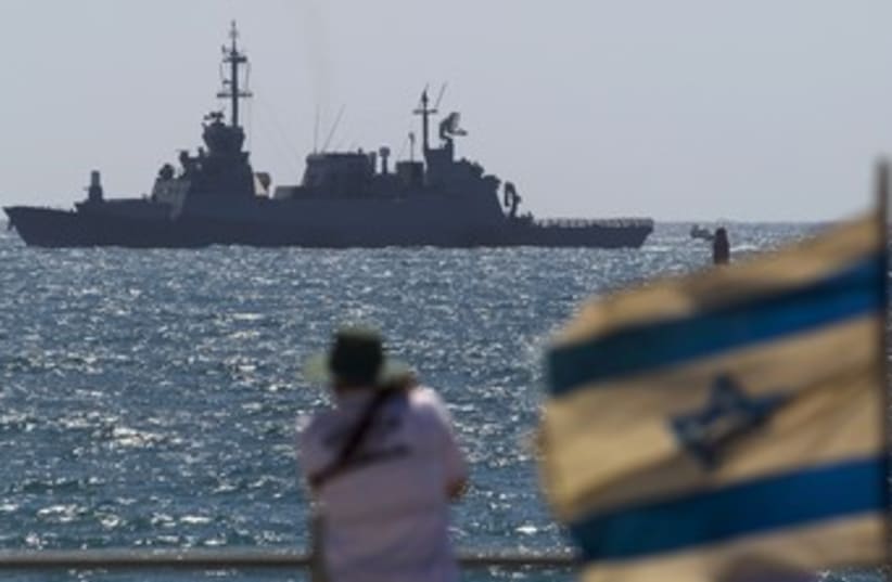 Man looks at Israeli Navy boat off Ashdod 370 (photo credit: Amir Cohen / Reuters)