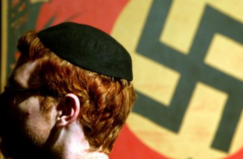 Jewish man in front of swastika 370 (photo credit: REUTERS)