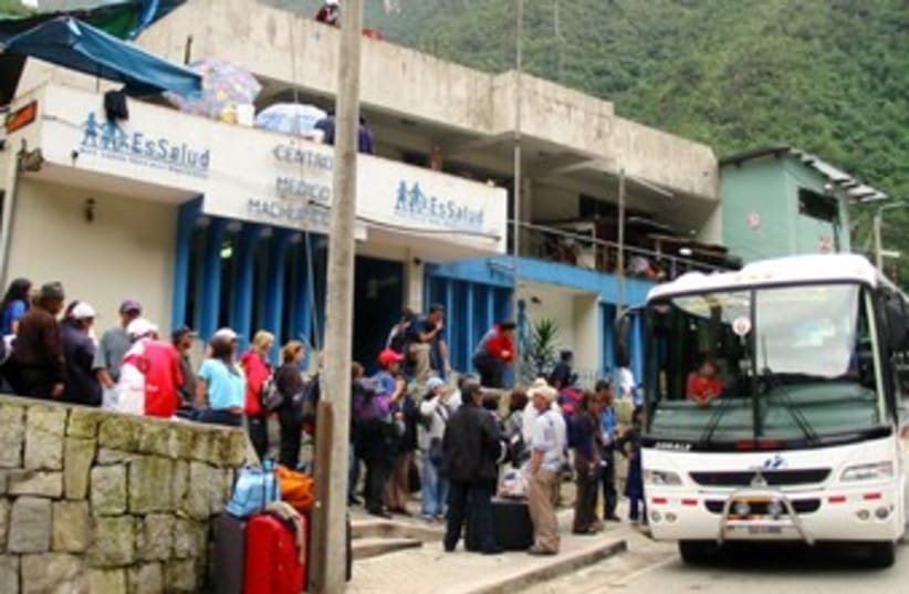 Tourists wait to get on bus in Cusco 370 (photo credit: REUTERS)
