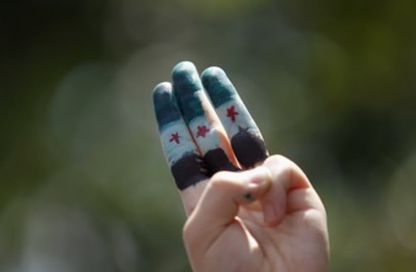 Syrian independence flag painted on fingers 370 (photo credit: 	 REUTERS/Bazuki Muhammad)
