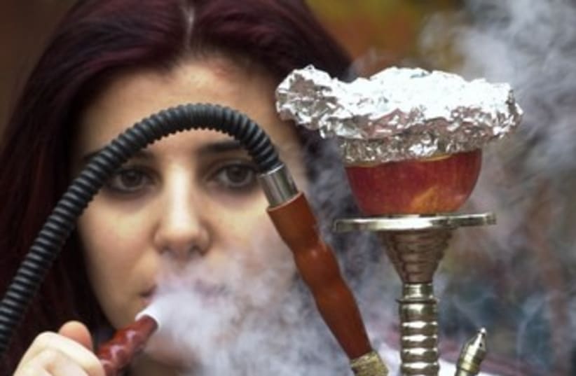 Woman smokes nargila from a hookah 370 (photo credit: REUTERS/Sharif Karim)