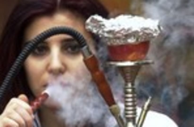 Woman smokes nargila from a hookah 150 (photo credit: REUTERS/Sharif Karim)