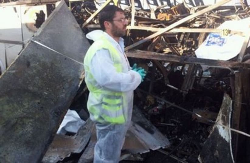 ZAKA man examines damage in Burgas 390 (photo credit: Avigdor Shatran)