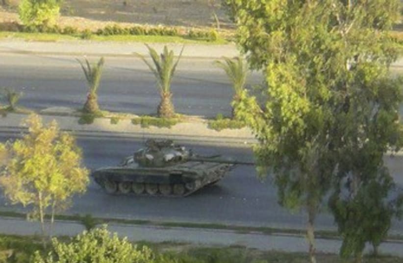 Syrian tank is seen in Damascus 370 (photo credit: REUTERS / Handout)